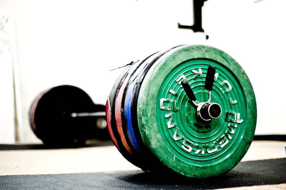 A barbell loaded up with weights ready for a weightlifter