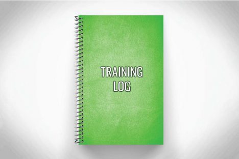 Green training log for workout tracking on grey background