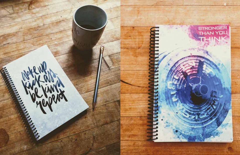 Build a fitness journal on wood table with coffee cup and pencil