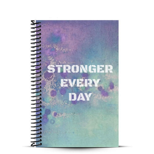 Blue and purple fitness journal with stronger every day quote on front